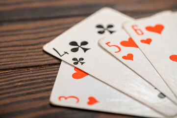 Playing cards on a wooden table.