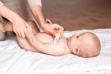 boy sick, fever. taking child's Temperature to measure, how high of body temperature Woman's hand holding digital thermometer. Baby healthcare concept