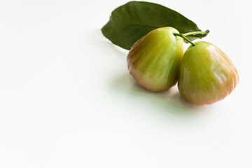 Whole rose apple with green leaf isolated on white background. Flat lay and copy space