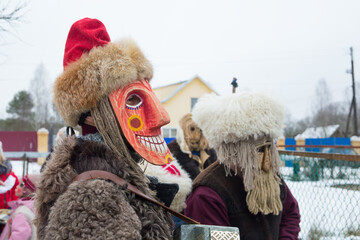 People in demon masks are caroling in a Russian village. folk holidays and customs in russia.