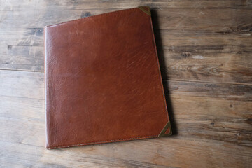 brown leather board on wooden background, Front Back of Restaurant Menu Folder in Leather, empty mock up