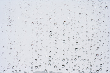 Drops of rain on the window or glass. Gray wet glass pattern texture. Abstract background