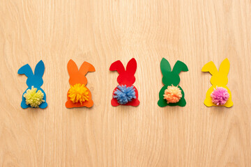 Garland of colourful bunnies on wood table. DIY for Easter