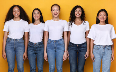 Obraz premium Group Of Five Cheerful Diverse Ladies Posing Over Yellow Background