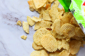 close up of potato chips spilling out from packet 