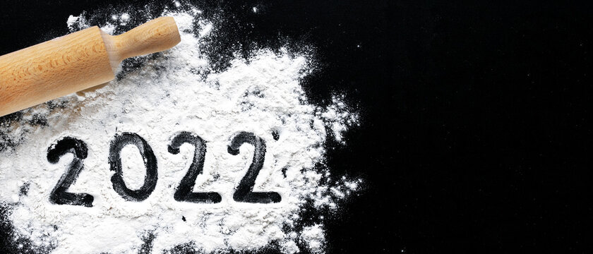 Preparation For Cooking Home Made Cookie. Baking Flour And Number 2022 On Black Board. Top View, Flat Lay With Space For Text. Rolling Pin, Flour And Shape New Year. New Year Ornament Food Background