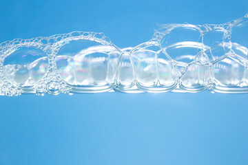 Soap bubbles on the blue background