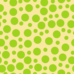 Seamless pattern of green circles of different diameters on a yellow background, positive pattern of round elements for design