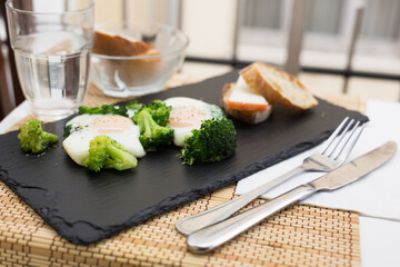 breakfast of crumpled eggs with broccoli