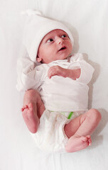 a newborn baby in a diaper in full growth lies in the doctor's office close-up.
