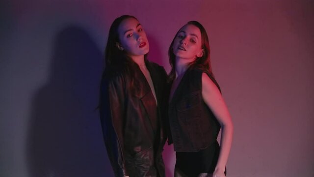 Footage of dancing women in red and blue light