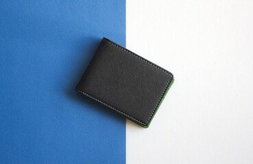 Black wallet isolated on white and blue background . Closed wallet . 