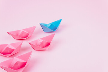 Pink and blue color origami paper boats.