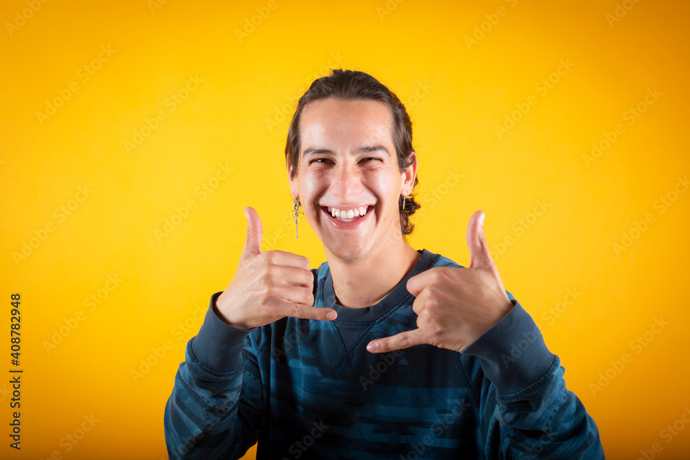 Wall mural happy man in casual clothes with his fingers on ok yellow background