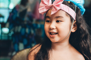 Portrait of Asian playful girl wearing dress with pretty headwear
