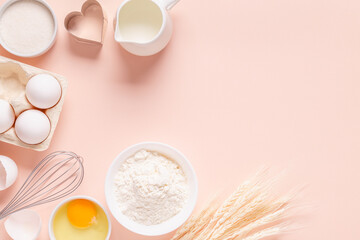 Ingredients for baking on light pink background.