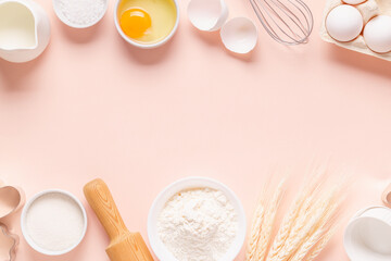 Ingredients for baking on light pink background.