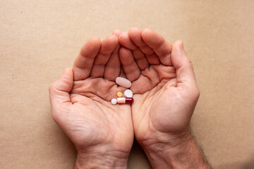 Male hand with medicines pills