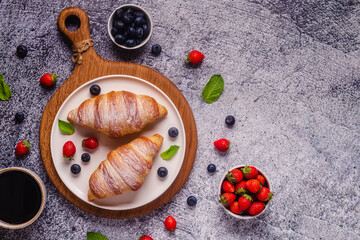 Breakfast with croissants and fresh fruits.