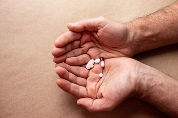 Male hand with medicines pills