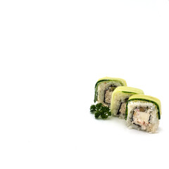 A set of three rolls with cucumber, cheese, fish. Decorated with a sprig of curly parsley. Isolated over white background. Bottom right corner.