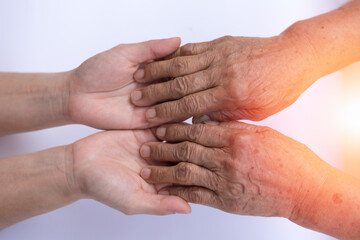 Fototapeta premium Caregiver, carer hand holding elder hand in hospice care. Philanthropy kindness to disabled concept.