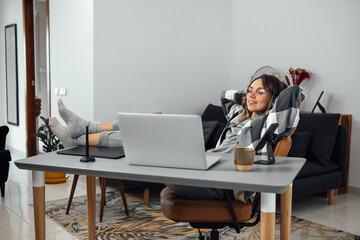 Fototapeta na wymiar Smiling female freelancer relaxed at comfortable chair hands behind head, at home office. Happy woman, student, resting satisfied after work done, enjoying break, no stress, dreaming about vacation.