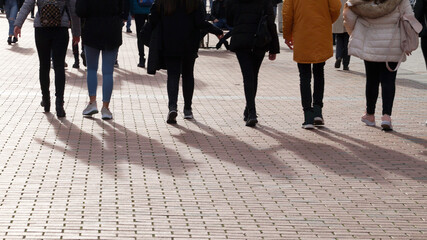 Obraz premium youth walking on the sidewalk, photo of the bottom