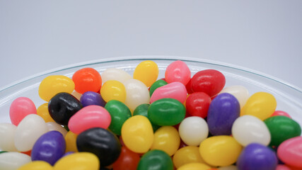 Bowl of colorful jelly beans with copy space above