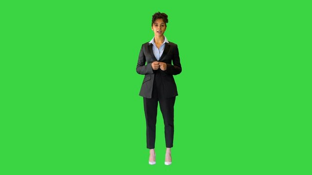 Young black businesswoman speaking to the camera on a Green Screen, Chroma Key.