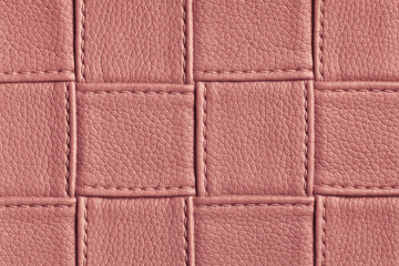 Fototapeta premium Texture of dark pink and rose leather background with square pattern and stitch.