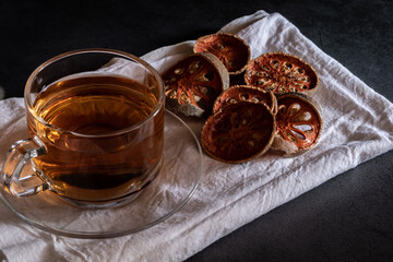 Hot bael fruit tea in a clear cup with hot steam Bael Fruit Tea made from dried bael fruit