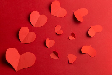 Use scissors to cut into heart-shaped pieces of paper