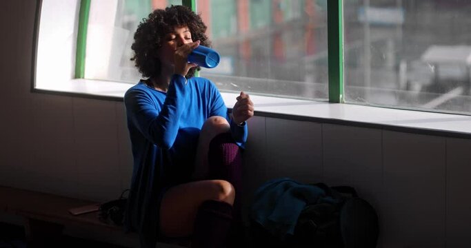 African-american woman drinking water on dance studio