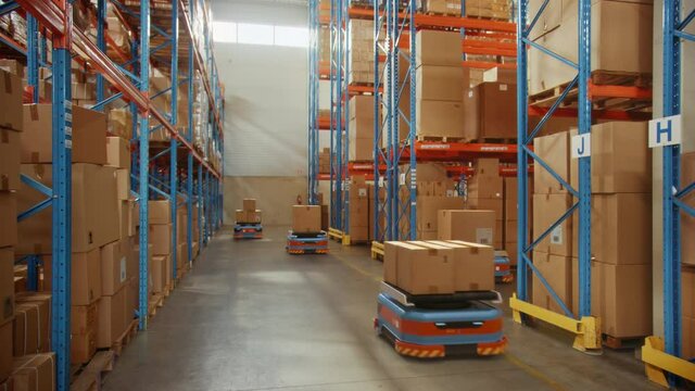 Future Technology 3D Concept: Automated Modern Retail Warehouse AGV Robots Transporting Cardboard Boxes in Distribution Logistics Center. Automated Guided Vehicles Delivering Goods, Products, Packages
