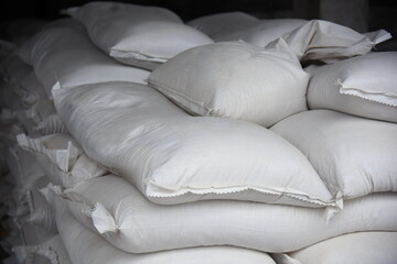 Close-up of bags of sugar in the warehouse of the processing plant, the products are ready for further use.