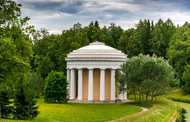 Fototapeta na wymiar Summer landscape in a city Park with trees, pavilion, sky with clouds