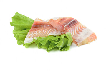 Pangasius fish fillet, pieces on a green lettuce leaf. Isolated on a white background. Fresh Fish Fillet.