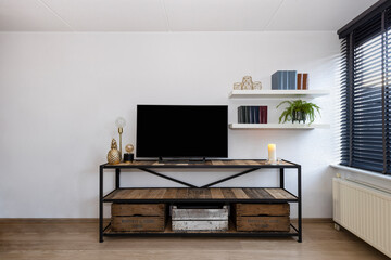Industrial style living room interior with television © Edwin
