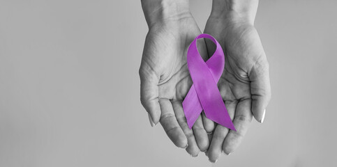 World cancer day inscription. healthcare and medicine concept - girl hands holding Purple cancer awareness ribbon. 4 february day
