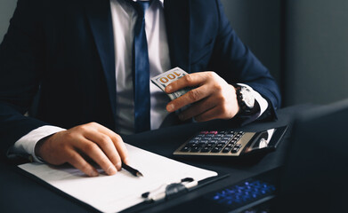 Businessman using calculator and laptop for calculate bills Finances, savings and economy concept....
