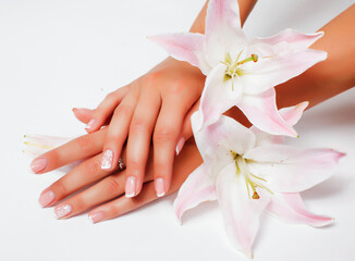 manicure pedicure with flower lily closeup isolated on white perfect shape hands spa salon