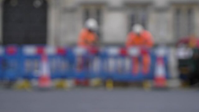 Defocused Wide Shot of Road Workers In Oxford England
