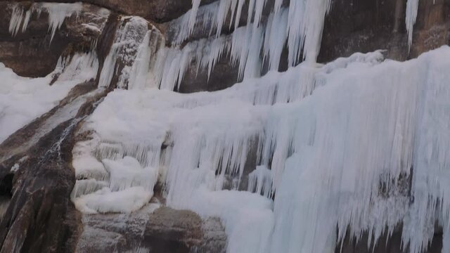 Chegem waterfall in the Caucasus Mountains in winter. The water froze into long icicles.