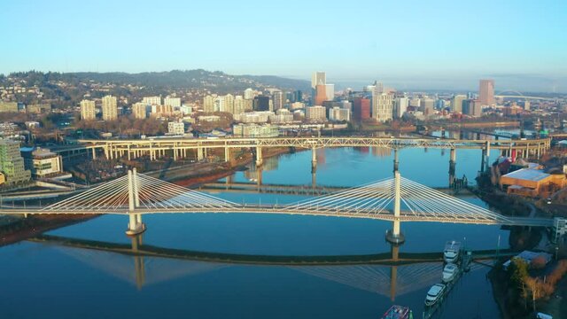 Flying down the Willamette River towards the Tilikum Crossing Bridge, Marquam Bridge in Portland Oregon at Sunrise