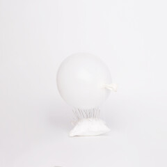 white on white color concept, soft light, abstract picture of inflatable balloon on needles, monochrome minimalism