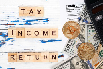 Personal income tax form 1040, dollar bills, bitcoins and calculator. Tax payment and filing concept. 