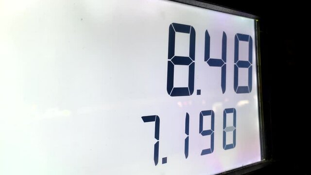Rising gas prices on station pump screen with 4k resolution.