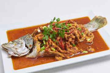 Crispy fried fish topped with delicious dipping sauce, a popular dish.