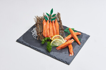 Crab sticks and sashimi served on a stone tray with beautiful decorations Popular dishes in Japan
